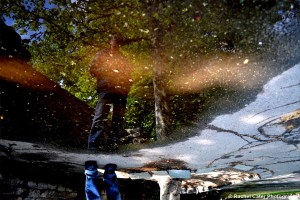 Long shot Reflections of Man in large Puddle in Prague Rachel Cater Photography
