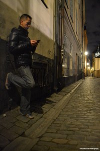 Man  leaning against a walll in old town Sweden Rachel Cater Photography
